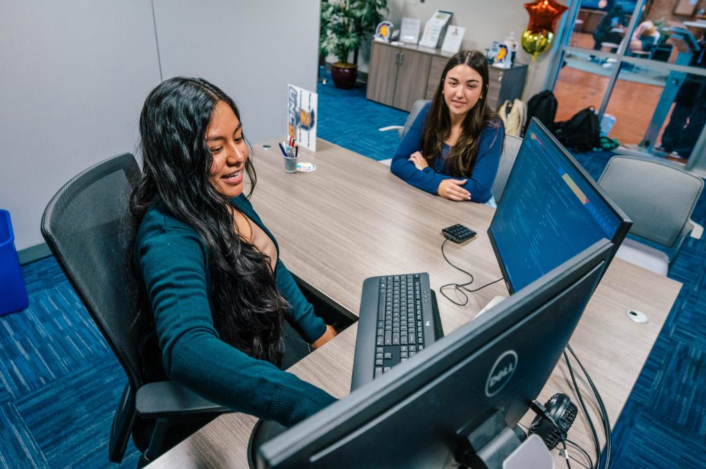 Students looking at computer